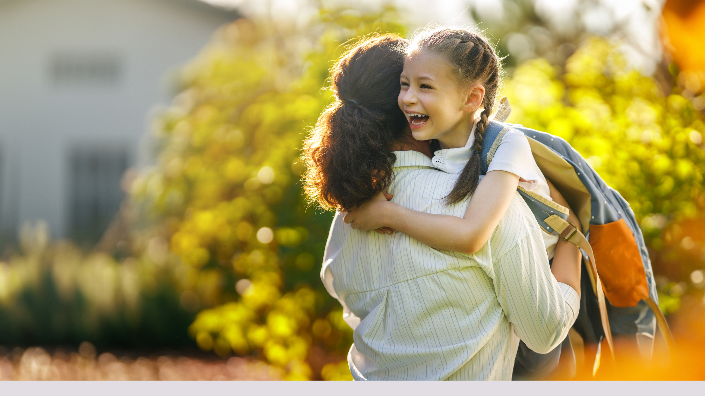 Mother hugging child before school