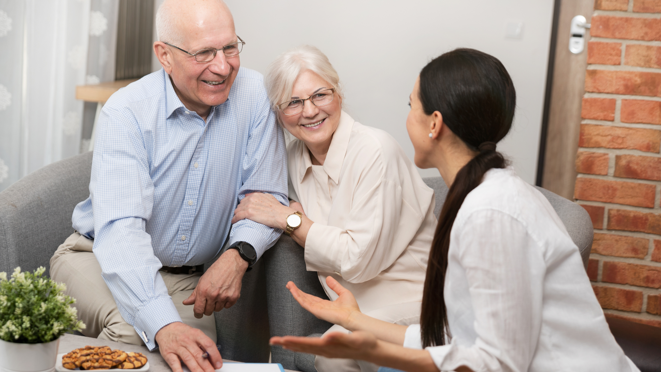 Older couple sitting down with lawyer discussing estate plan