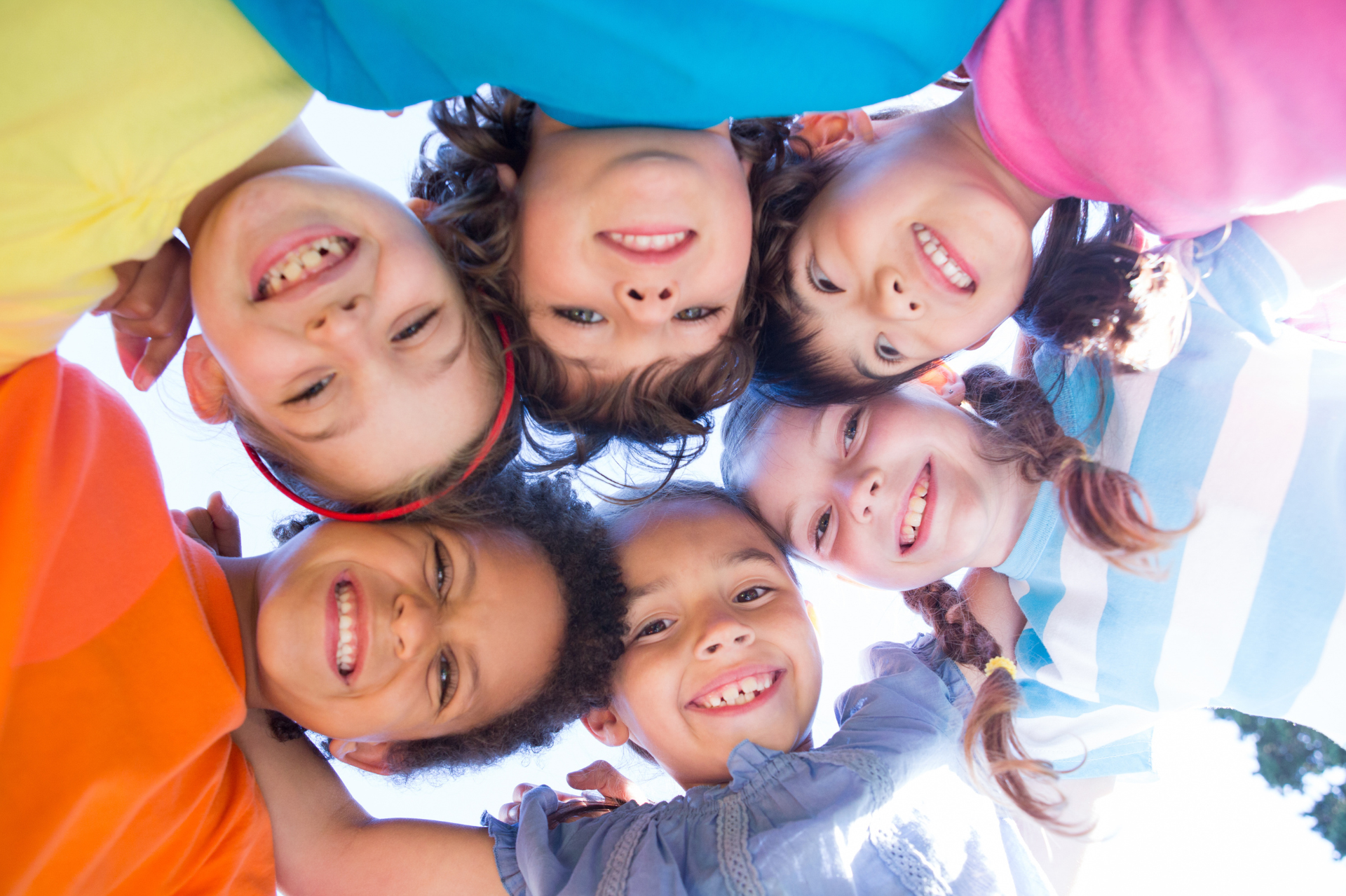 Kids in a circle smiling